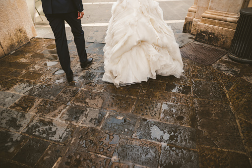 Bride and Groom walking on a rainy day