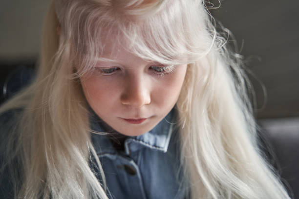 istock Kid sitting at the table and drawing or writing something 1325185108