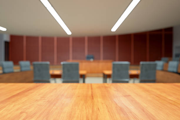 Empty Courtroom Interior With Wooden Desk And Blurred Background Empty Courtroom Interior With Wooden Desk And Blurred Background courtroom stock pictures, royalty-free photos & images