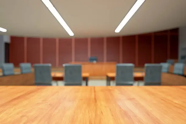 Empty Courtroom Interior With Wooden Desk And Blurred Background