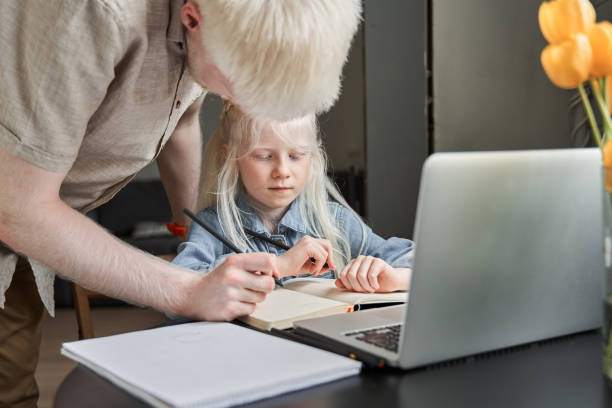 istock Girl stuck with hard task and preparing homework with caring her bearded father 1325188738