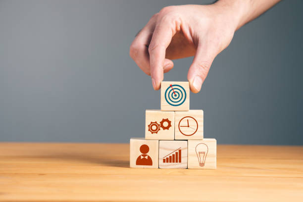 istock holding wooden cubes and goals 1325189948