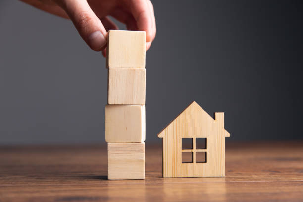 istock wooden cubes and house model 1325190557