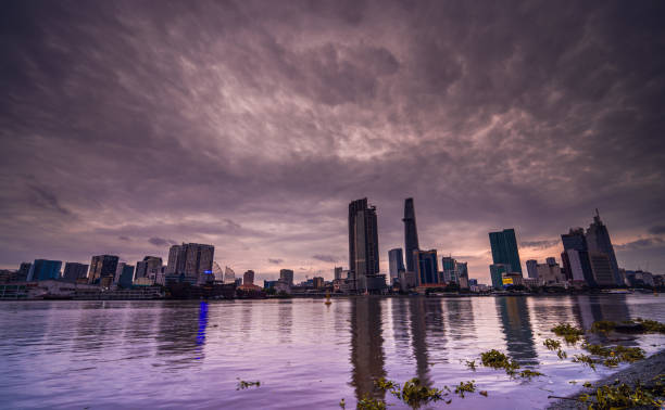 Sunset view of Bitexco Financial Tower, buildings, roads and Saigon river in Ho Chi Minh city Sunset view of Bitexco Financial Tower, buildings, roads and Saigon river in Ho Chi Minh city - This city is a popular tourist destination of Vietnam. thu thiem stock pictures, royalty-free photos & images