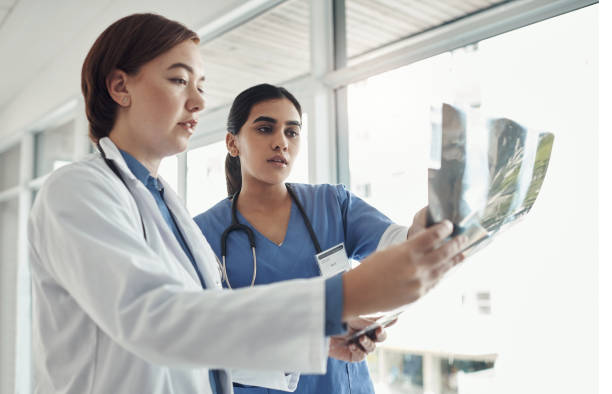 istock Shot of two young doctors checking exrays in a hospital 1325190882