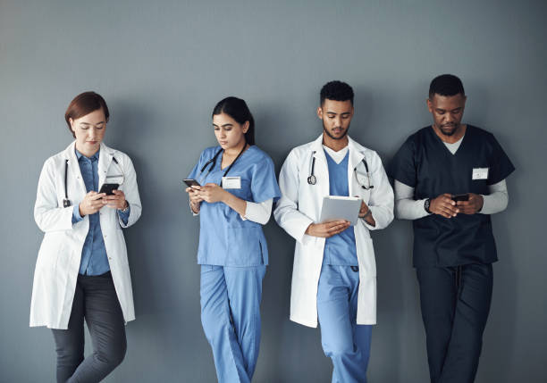 istock Shot of a group of doctors standing against a grey background at work 1325190905