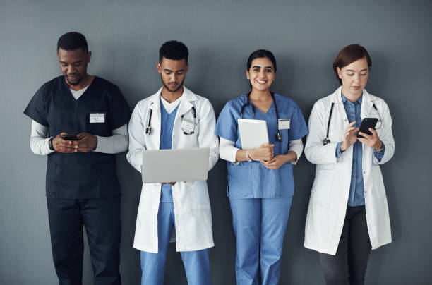 istock Shot of a group of doctors standing against a grey background at work 1325190909