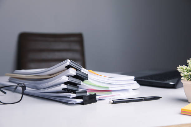 istock Stack of business paper file with laptop computer 1325193324