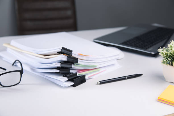 istock Stack of business paper file with laptop computer 1325193326