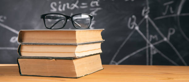 istock glasses on book with chalkboard 1325193370