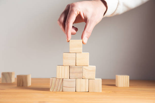istock business man holding wooden cubes 1325193424