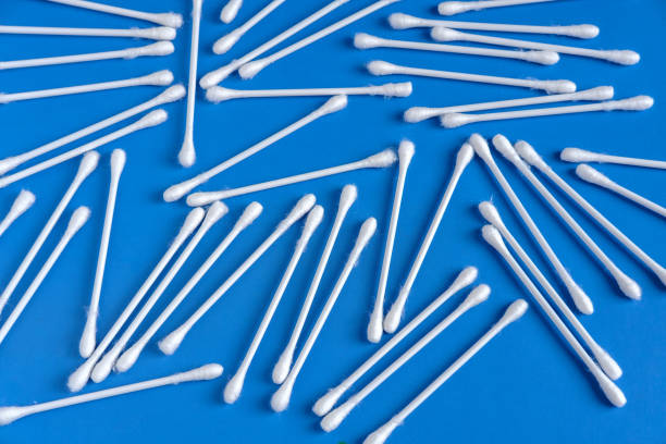 istock Cotton buds are scattered on a blue background. 1325193882