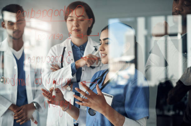 istock Shot a group of doctors discussing formulas in the office at work 1325195218