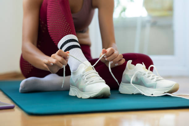 istock Woman tying her sneakers preparing for workout 1325195400
