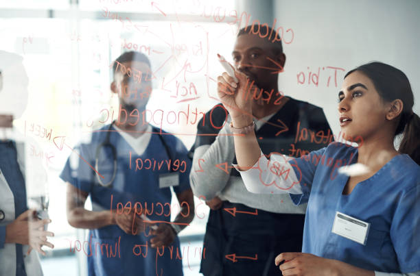 istock Shot a group of doctors discussing formulas in the office at work 1325195464