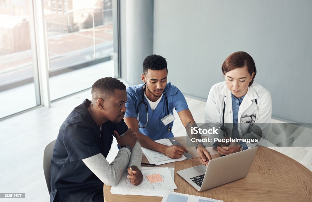 Shot a group of doctors discussing work matters in the office at work Studying for our finals Nurse Stock Photo