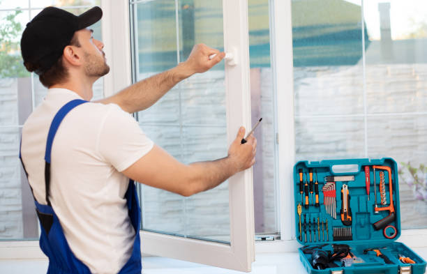 istock Young professional worker man in uniform suit is installing window with help of tools 1325195732