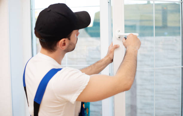 istock Young professional worker man in uniform suit is installing window with help of tools 1325195749