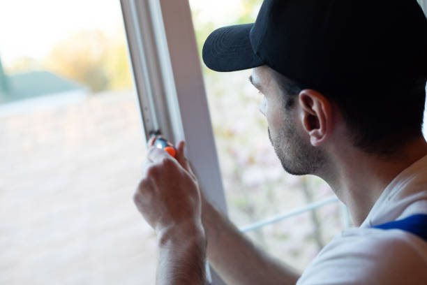 istock Young professional worker man in uniform suit is installing window with help of tools 1325195770