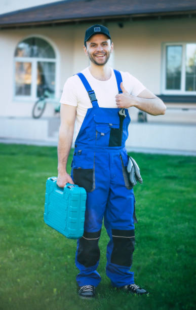 istock Handsome confident workman in special uniform with a modern toolbox is posing on a new big house background 1325195953