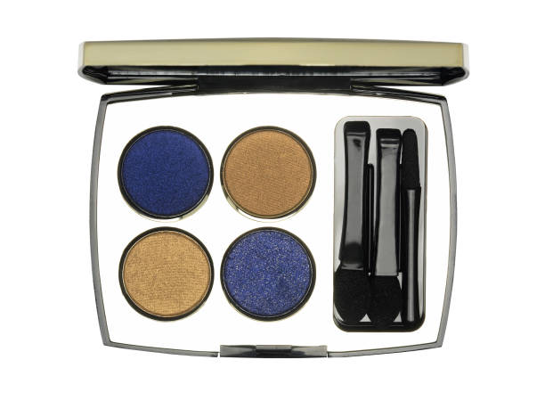 istock Open cosmetic set with eye shadows and applicators in golden case isolated 1325196689