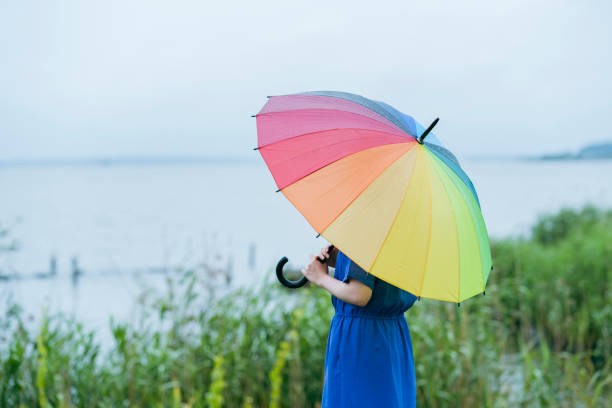 istock A woman holding a colorful umbrella 1325197160