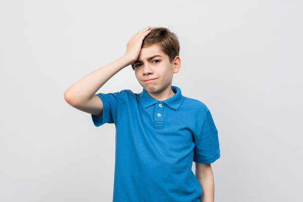 istock Shocked teen boy look puzzled and amazed, holding hand on head, staring at problem, forgot remember something 1325200230