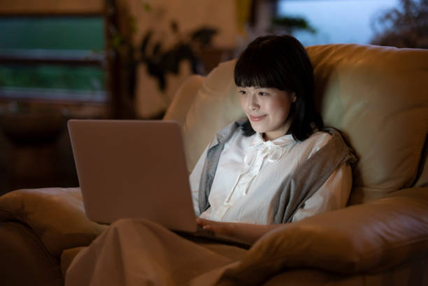 istock A young woman using a laptop on the sofa in a room 1325201419