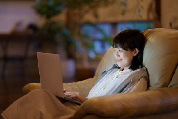 istock A young woman using a laptop on the sofa in a room 1325201448