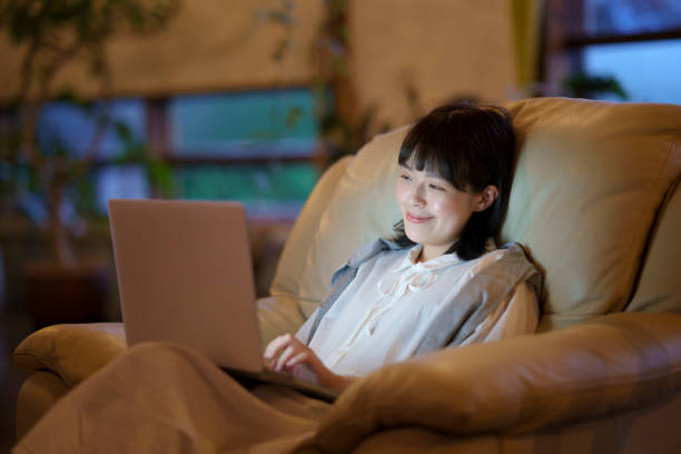 istock A young woman using a laptop on the sofa in a room 1325201467