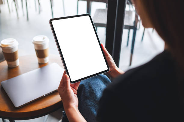 istock a woman holding digital tablet with blank white desktop screen 1325202093