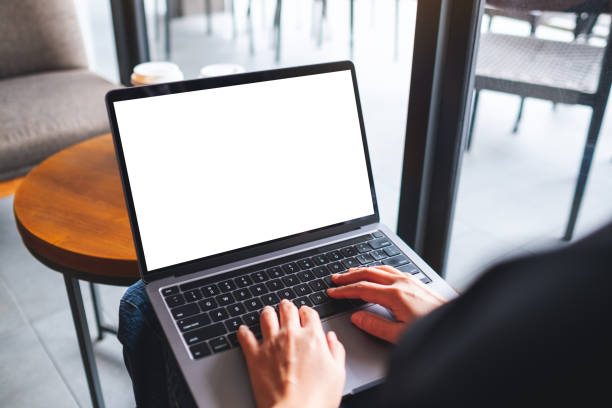 istock a woman using and typing on laptop computer with blank white desktop screen in cafe 1325202102