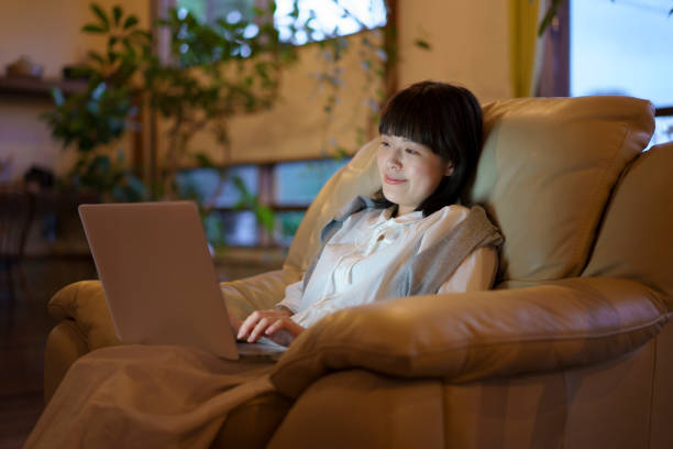 istock A young woman using a laptop on the sofa in a room 1325202121