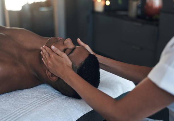 istock Shot of a young man getting a face massage at a spa 1325202759