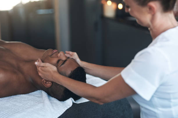 istock Shot of a young man getting a face massage at a spa 1325202763