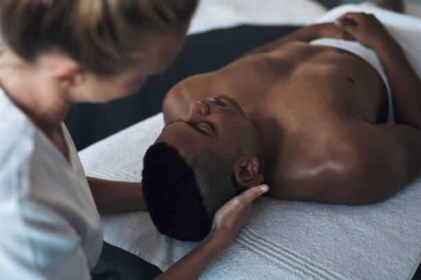 istock Shot of a young man getting a face massage at a spa 1325202770