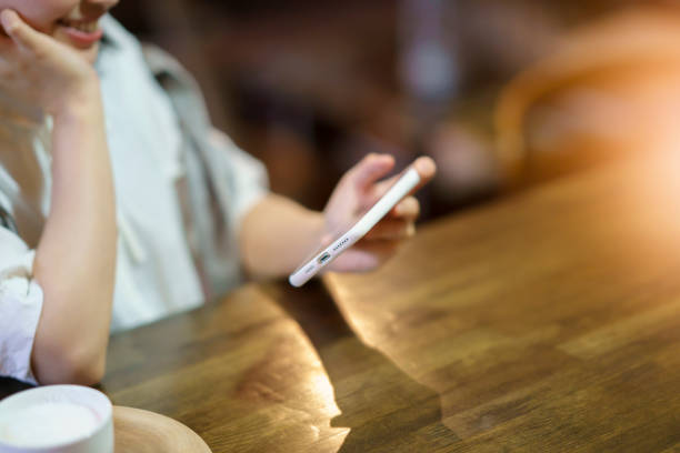 A young woman looking at a smartphone screen