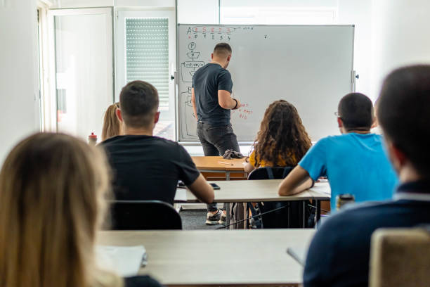 istock Latin American young man teaching a class to a group of college students 1325205709
