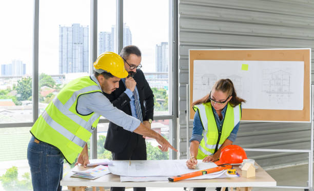 istock Engineers team meeting for architectural project. architects discussing blueprint with construction manager in office worker conference site. Construction Concept 1325205920