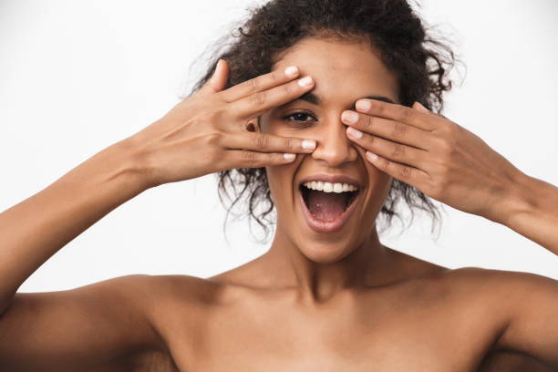 istock Happy young african woman posing isolated over white wall background. 1325206012