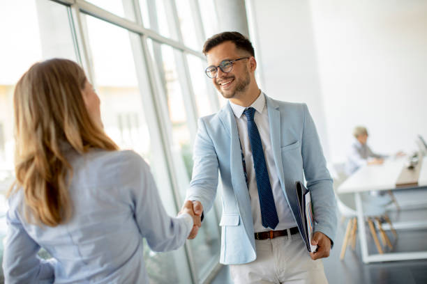istock Young business partners making handshake in an office 1325207874