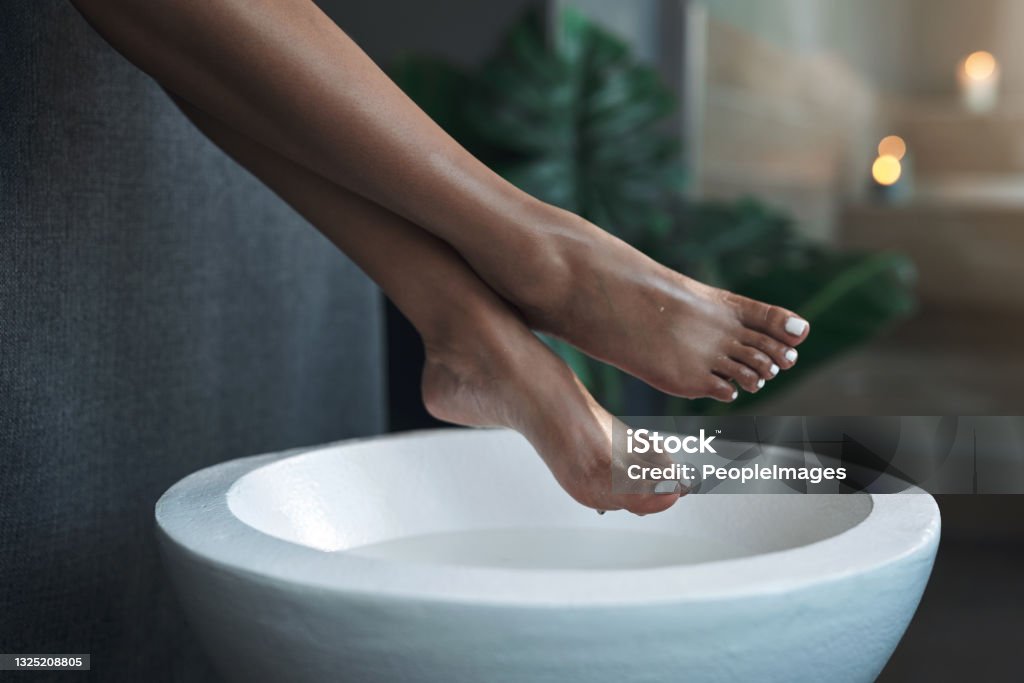Closeup shot of an unrecognisable woman getting a foot treatment at a spa Soak for some softness Pedicure Stock Photo