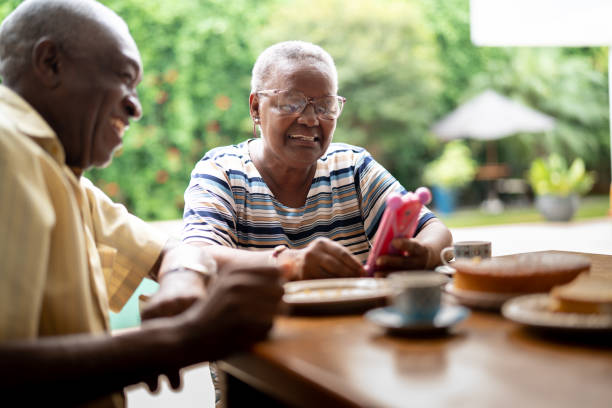 istock Senior couple using mobile on breakfast at home 1325208811