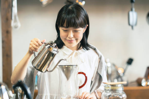 istock A young woman brewing coffee 1325208835