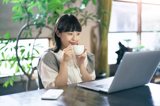 A woman looking at a laptop screen