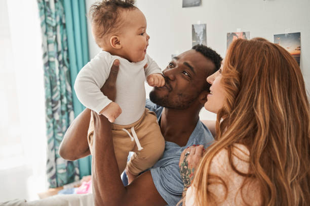 istock Multiracial father holding his son and looking at him with love 1325210547