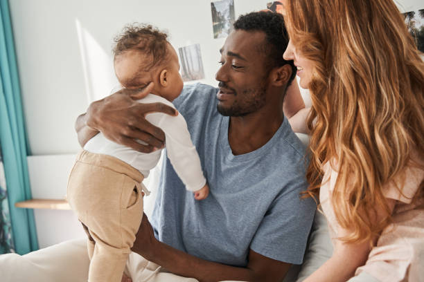 istock Multiracial father holding his son and looking at him with love 1325210548