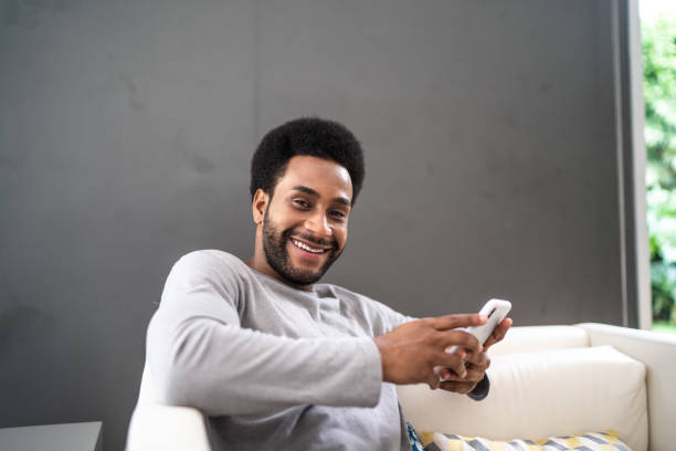 istock Portrait of a man using smartphone at home 1325211521