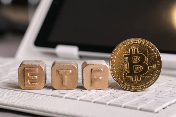letters Gold ETF and Bitcoin on white keyboard Kiev, Ukraine - June 23, 2021: letters Gold ETF and Bitcoin on white keyboard exchange traded fund stock pictures, royalty-free photos & images