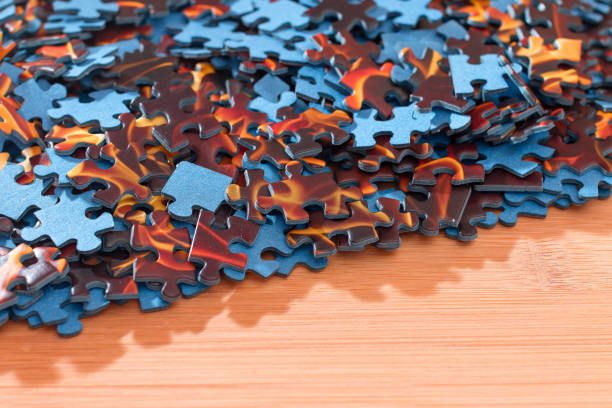 istock Mixed Jigsaw Puzzle Peaces on Wooden Table 1325211757
